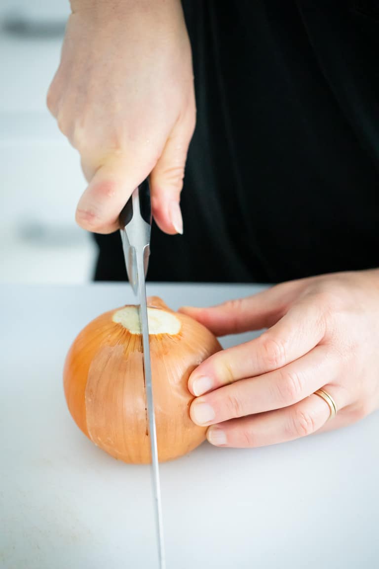 Cut the onion through the stem and root end