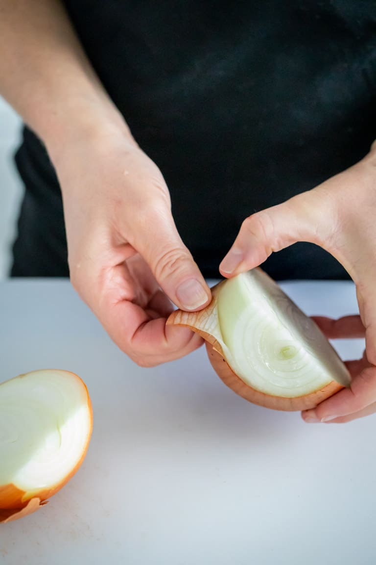 remove the skin and outermost layer of onion