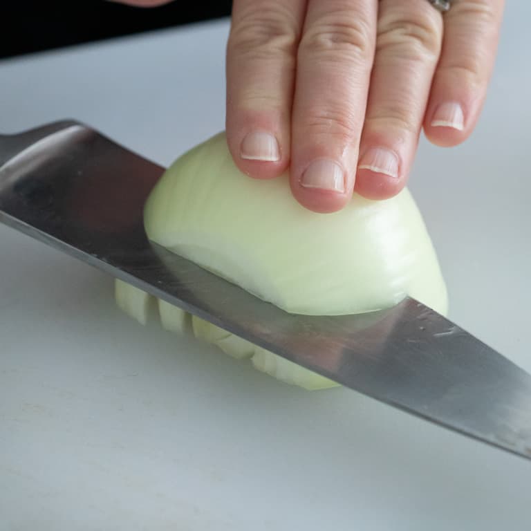 Slice onion into slabs stopping just before you get to the root end. The root end will hold the onion together as you slice it.