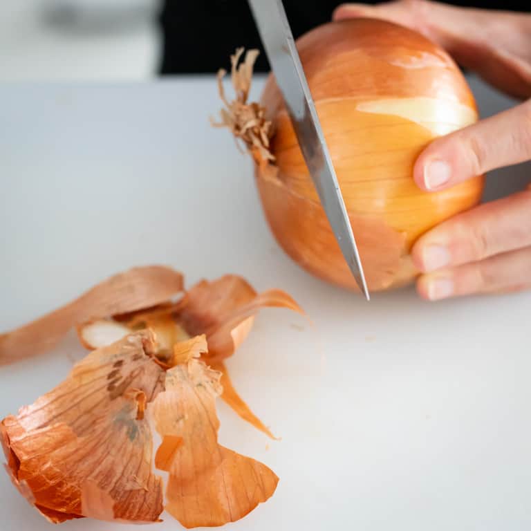 Remove the stem end of the onion