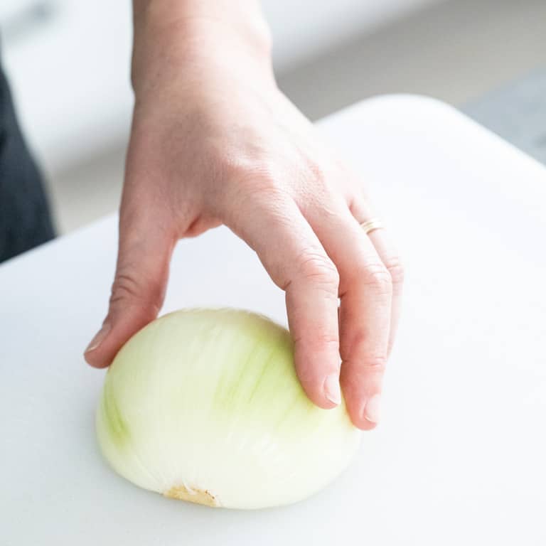For maximum stability, lay onion cut-side-down on work surface