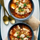 Two bowls of keto chicken soup with two spoons