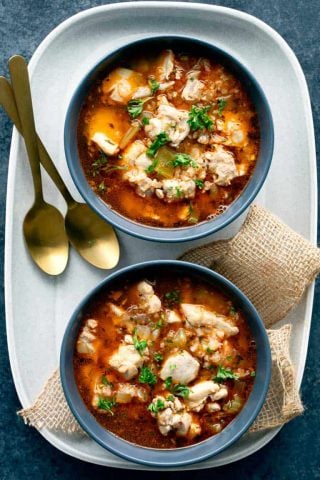 Two bowls of keto chicken soup with two spoons
