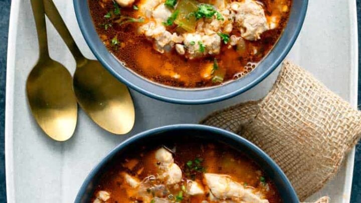 Two bowls of keto chicken soup with two spoons