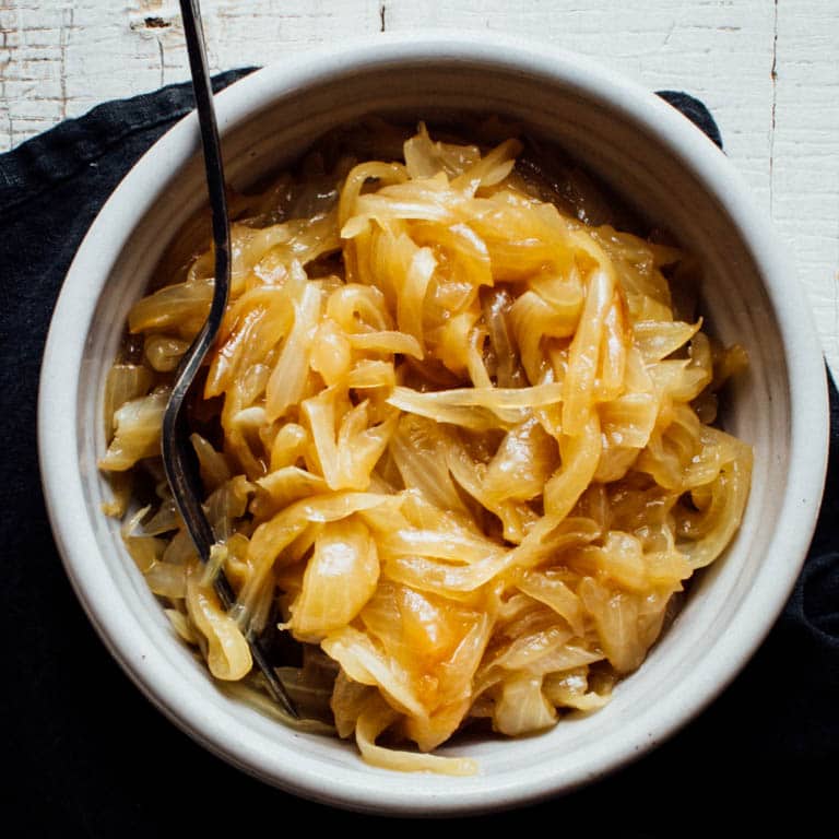From hair growth to curing a common cold, there are many questions about these staple veggies. Ever wondered where onions came from? Or how do onions grow? And then there is the ongoing question of how do you caramelize one, or can onions be frozen? Look no further than this Ultimate Guide to Onions to learn everything about growing, cooking and nourishing about these lovely alliums. | Healthy Seasonal Recipes by Katie Webster #onions #caramelize #dice #producespotlight #seasonal