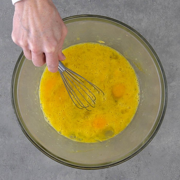 Whisk egg, mustard, salt and pepper in a bowl.