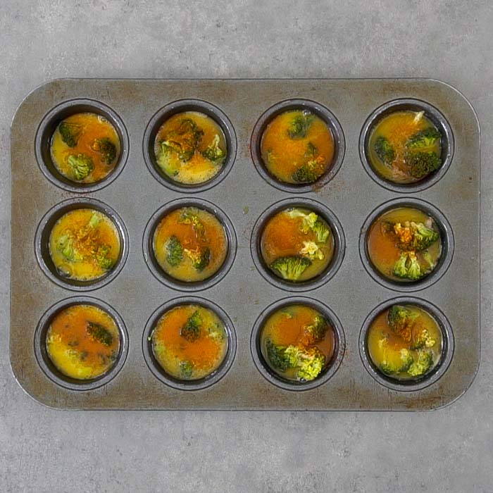 Pour the egg mixture into the muffin tin wells