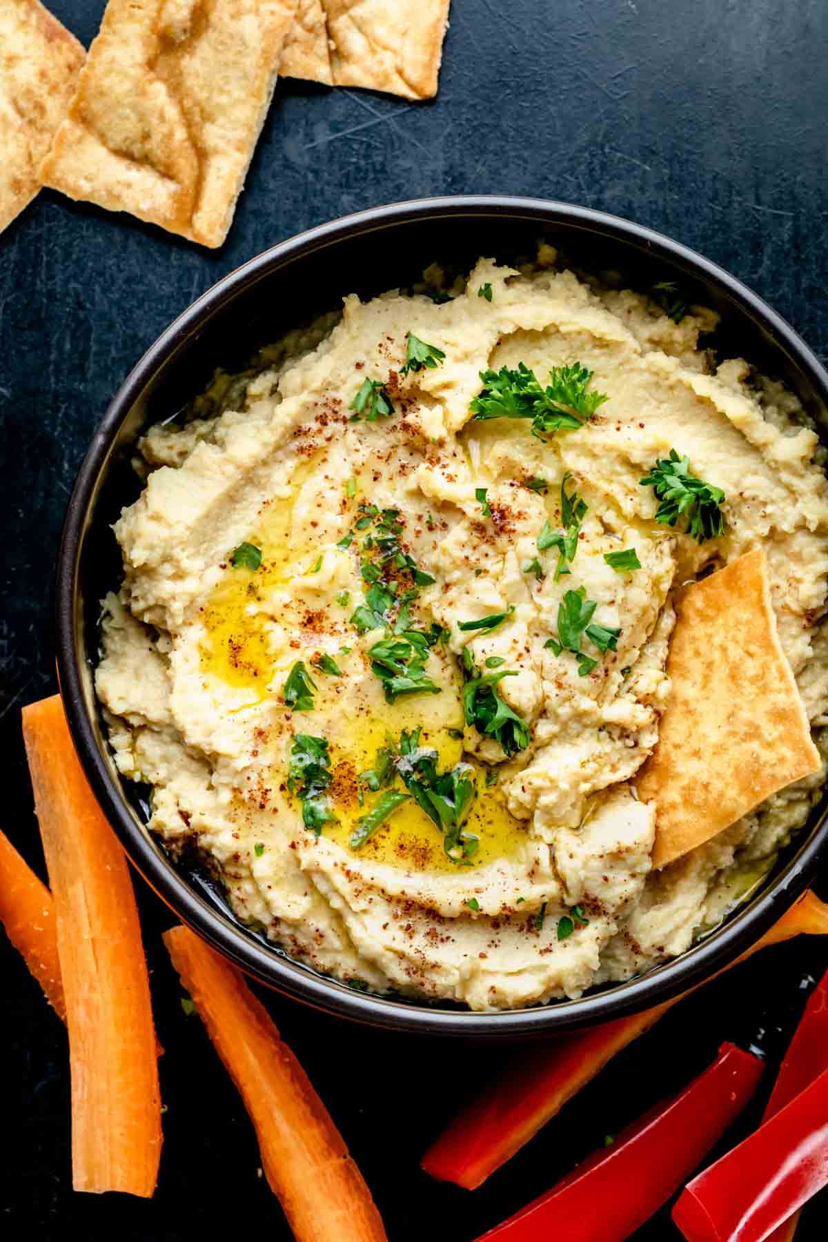 the hummus with a pita chip in it