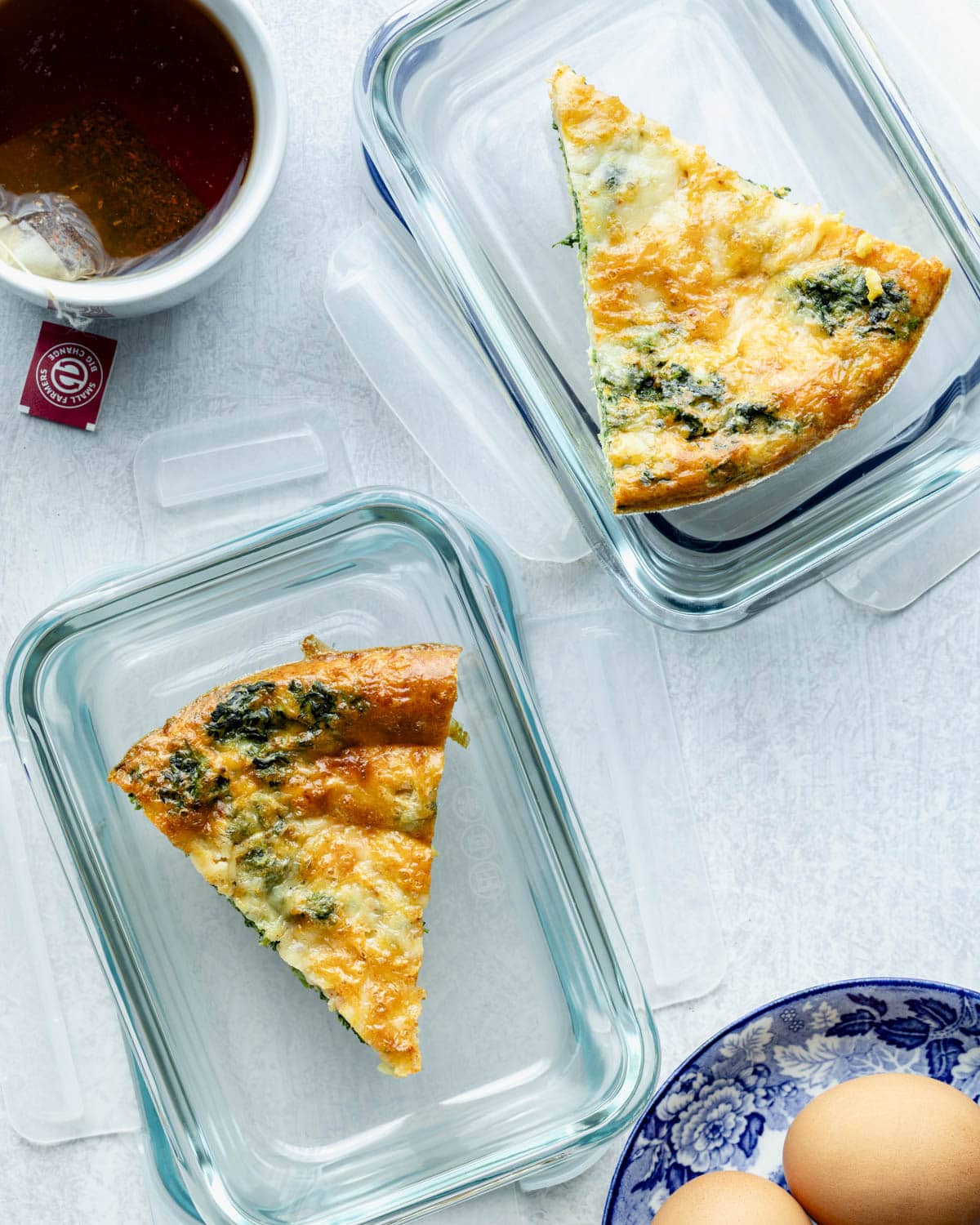 two slices of the egg bake in meal prep containers