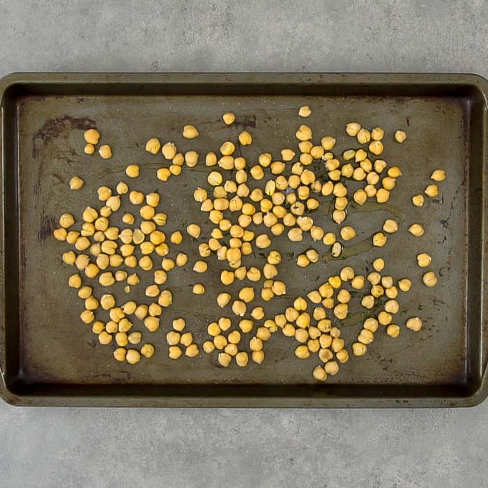 Spread the chickpeas out on a baking sheet and drizzle with oil