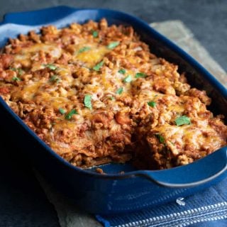 Layered Chicken Enchilada Casserole in a baking dish