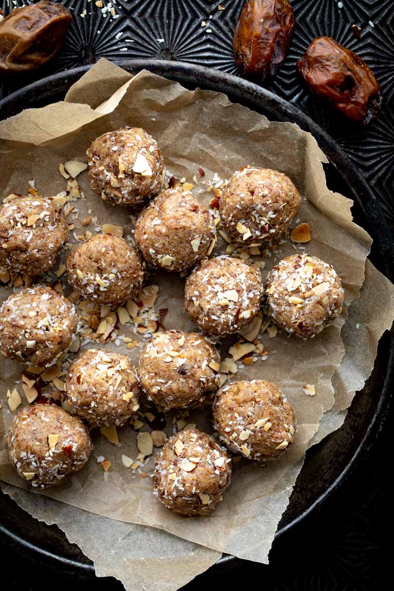 a metal tin plate filled with paleo energy balls