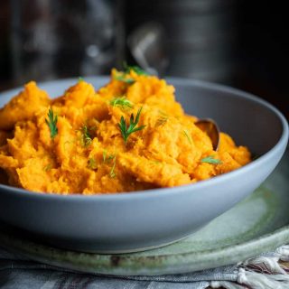 Mashed Carrots and Parsnips in a Gray Bowl.