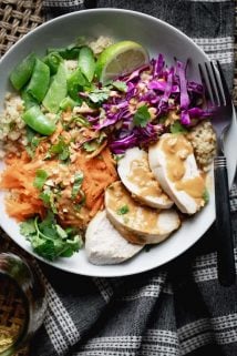 a close up of chicken quinoa bowl with peanut dressing