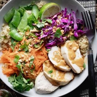 a close up of chicken quinoa bowl with peanut dressing