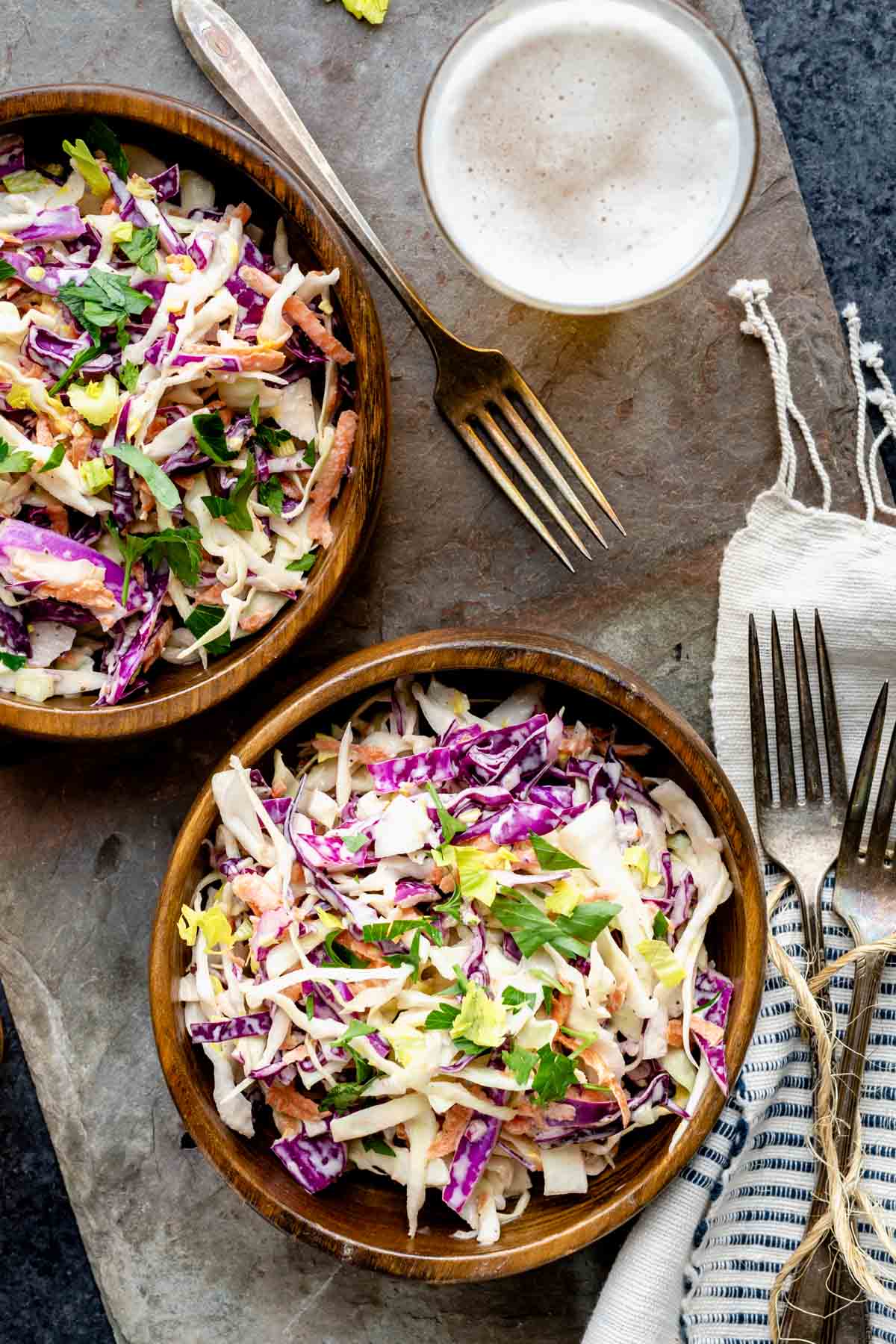 two wooden bowls with slaw in them