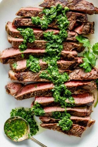 the steak with the sauce on it