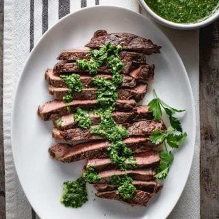 close up of sirloin steak with chimichurri