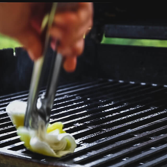 Oil the grill rack by dragging an oil soaked towel along the grill grates.