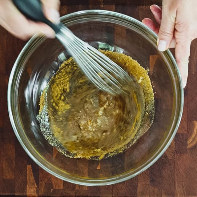 Scrape the garlic paste into a large bowl and add the vinegar, oil and cumin.