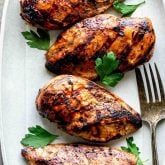a gray platter with four pieces of chicken