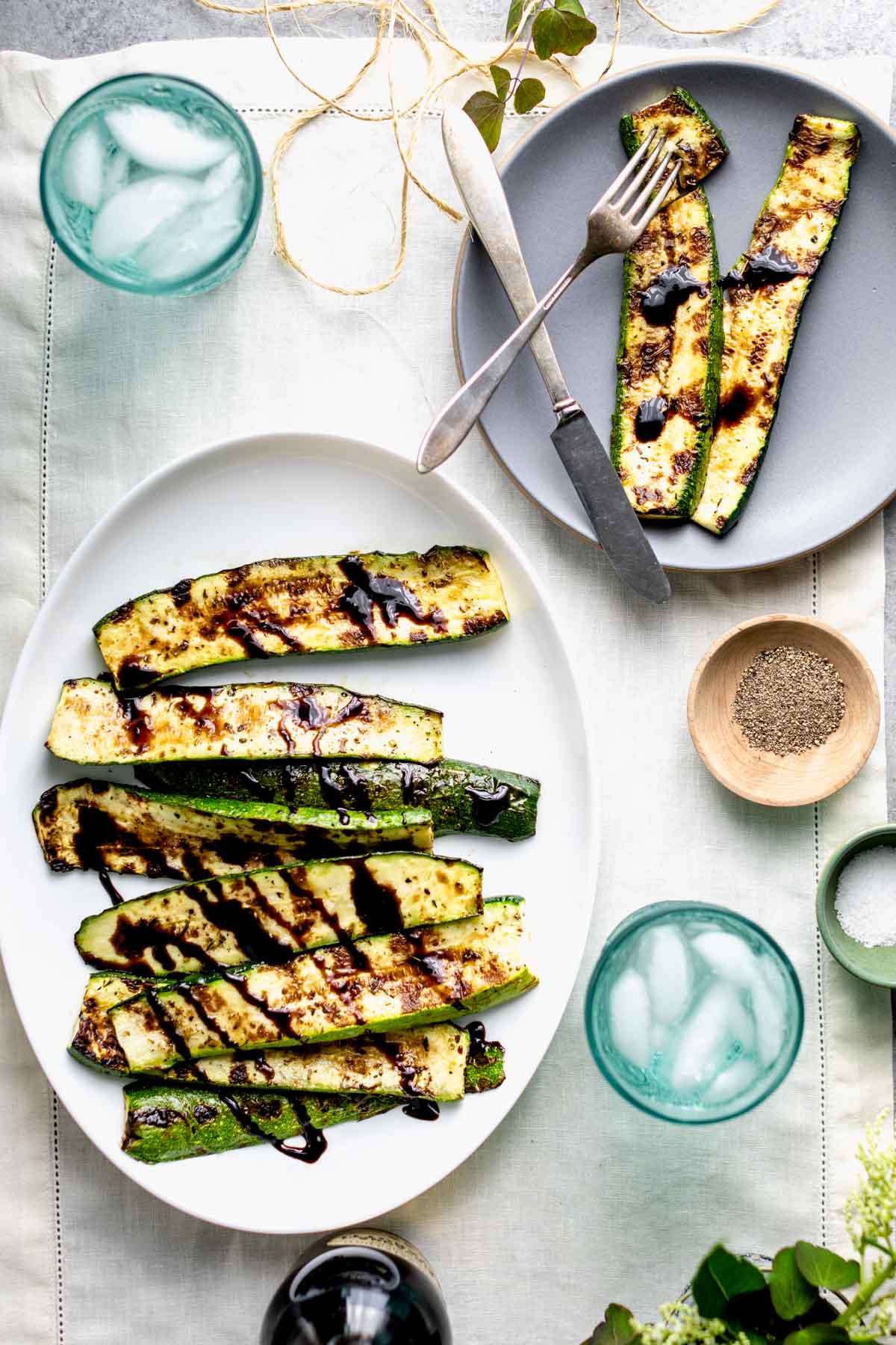Grilled zucchini from overhead with green scissors, twine and clippings from the garden