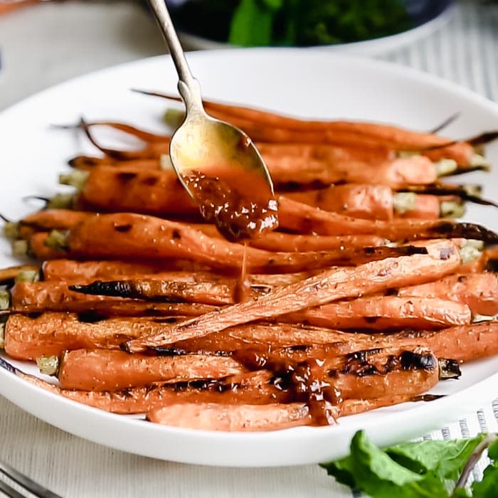 Serve the grilled carrots drizzled with the sauce