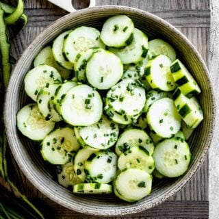 close-up of ceramic bowl with cucumber salad with chives