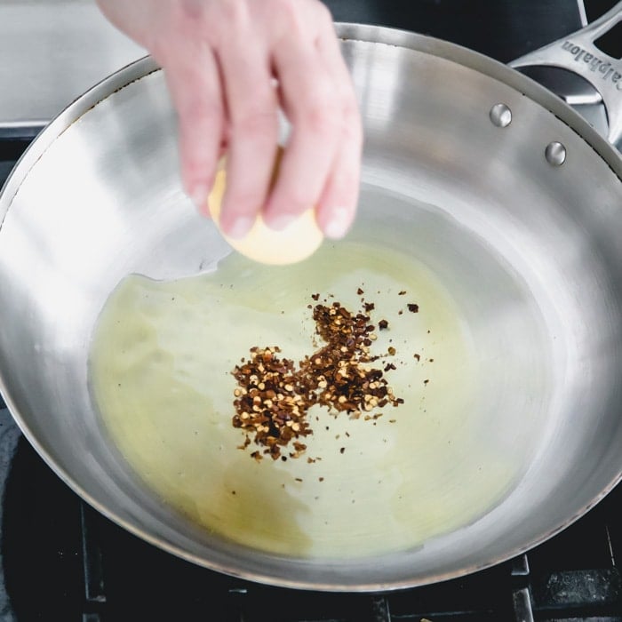 add hot chili flake to the hot oil in the pan
