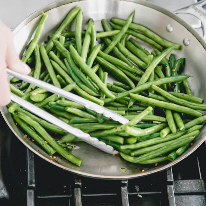 stir green beans until they are blistered and browned in spots