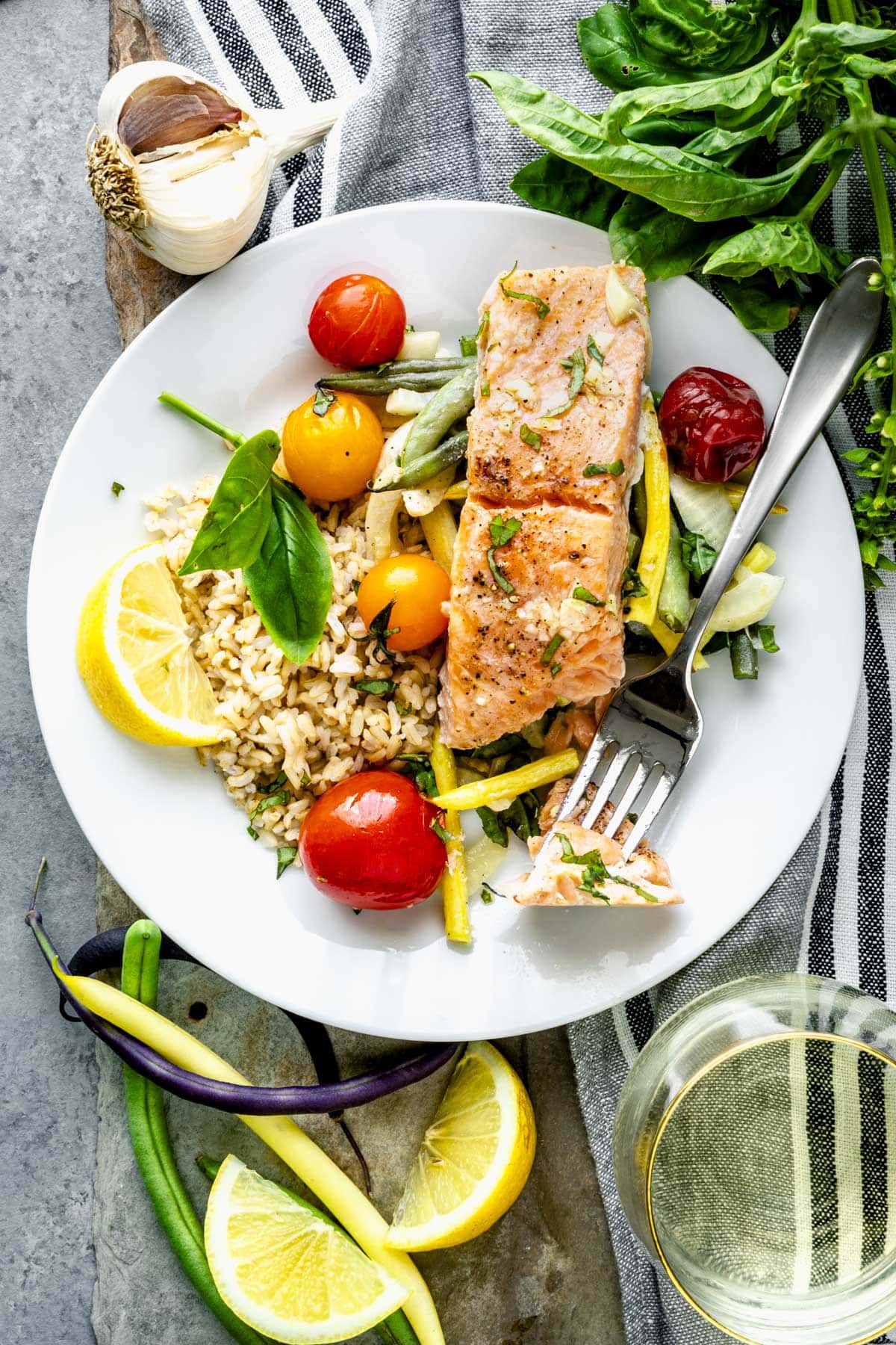 a small bite of the salmon on a fork resting on the plated dish