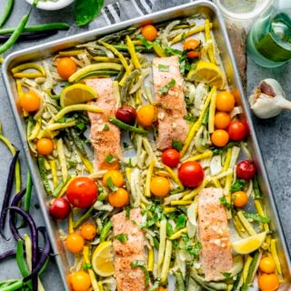 the salmon sheet pan recipe with veggies close up overhead on a table top with green beans on it