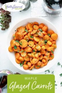 a white table and a white bowl with glazed carrots in it