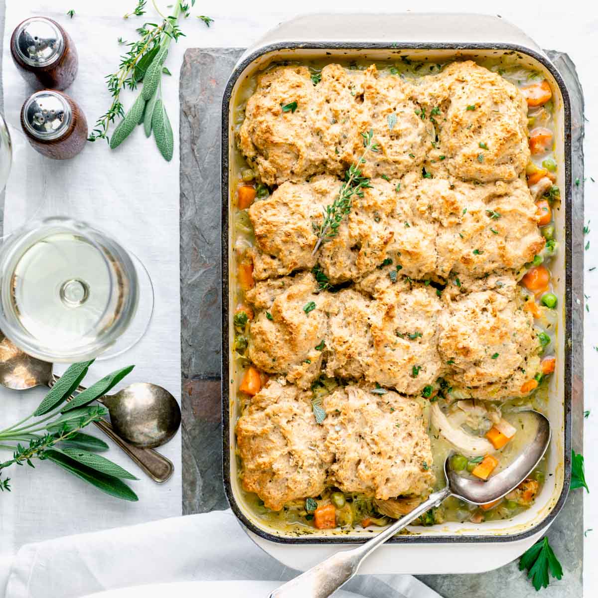 the casserole with a serving removed with a serving spoon in it
