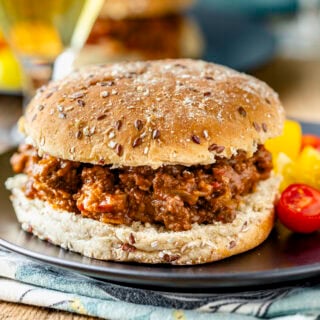 the sloppy joe on a bun with cherry tomatoes on the side
