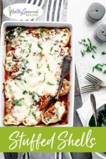 stuffed shells in a casserole dish with one shell in a spoon