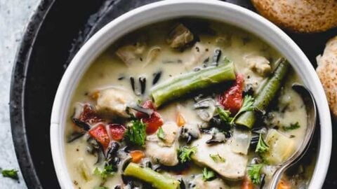 A close up overhead view of creamy chicken and wild rice soup