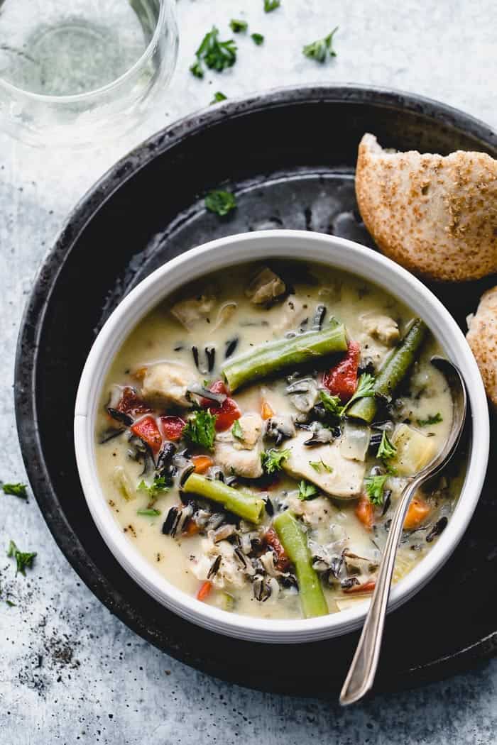 A close up overhead view of creamy chicken and wild rice soup