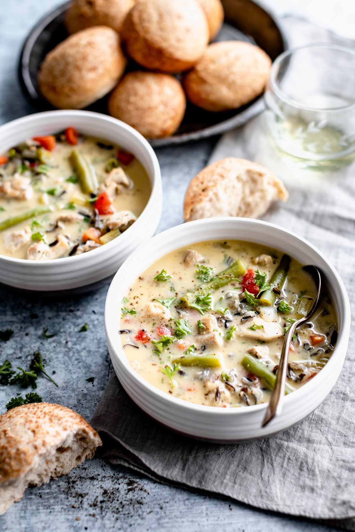 two bowls of soup with rolls