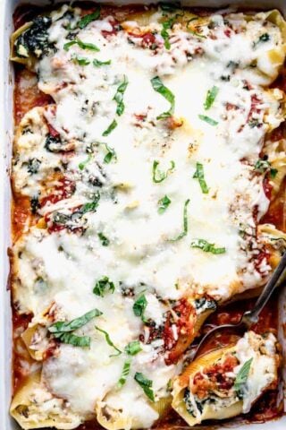 A close up overhead view inside a baking dish with stuffed shells