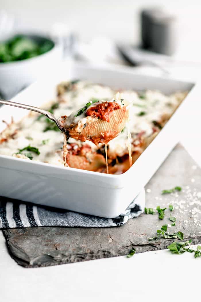 A side view of stuffed shells with spinach