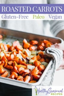 holding sheet pan of carrots