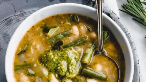 Soupe au pistou from overhead in a white bowl on a gray pie plate