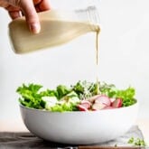 pouring dressing over salad