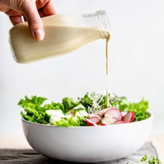 tahini dressing pouring over salad