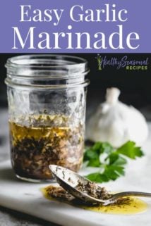 a jar of garlic marinade with a spoonful in front