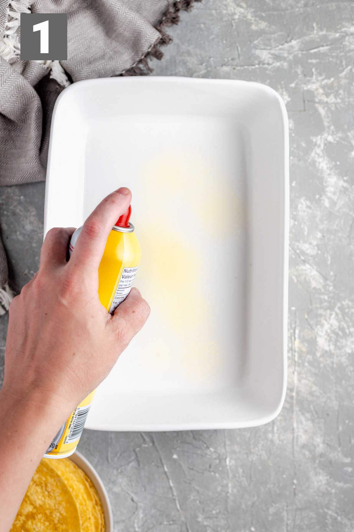 spraying the casserole dish