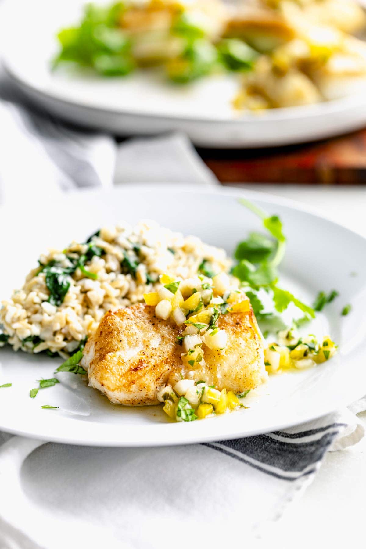 golden brown fried fish with pineapple salsa on top
