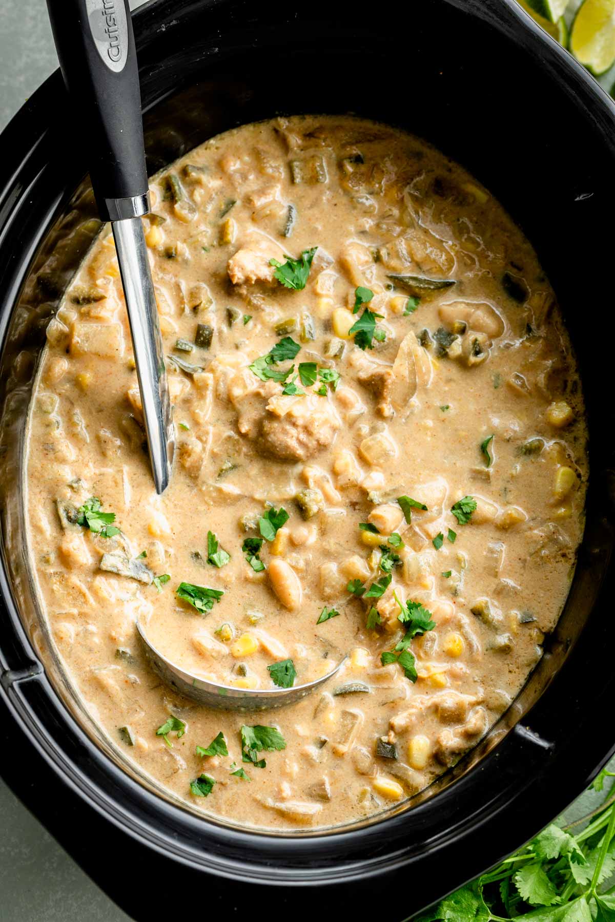 black crockpot filled with the creamy white chili