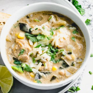 A close up of chicken chili and cheese and cilantro